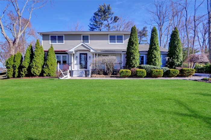 Traditional-style home with a porch and a front yard
