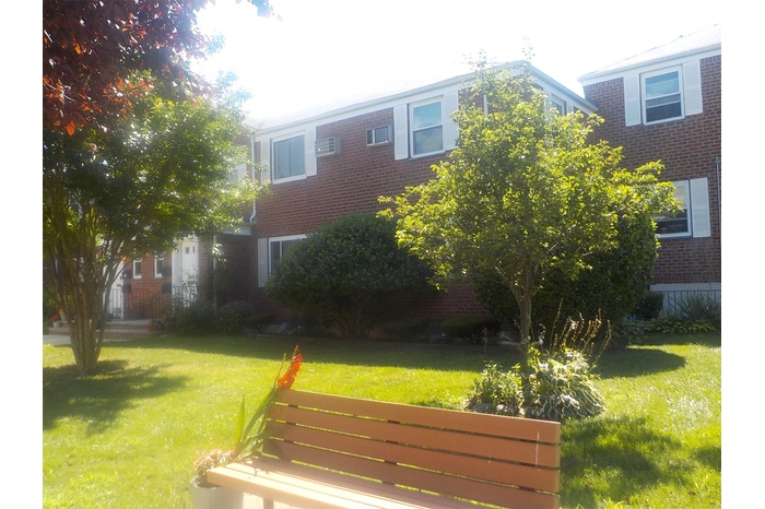 View of front of home with brick siding and a front yard