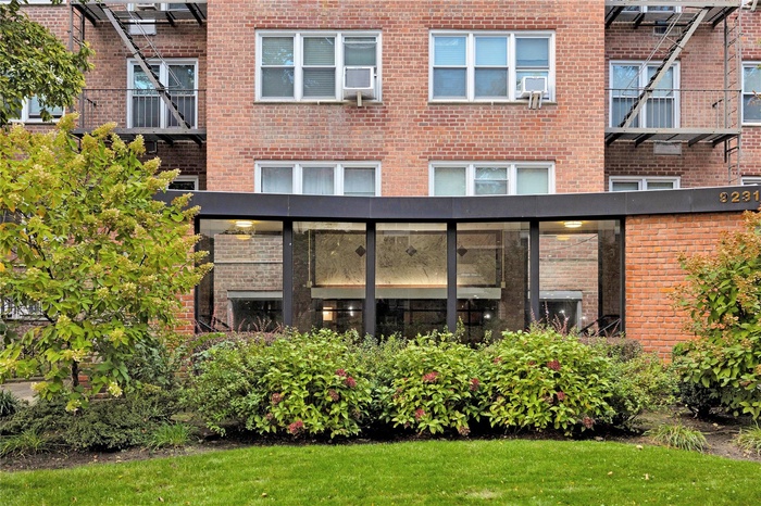 Rear view of property featuring brick siding