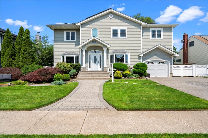 View of front of home with decorative driveway