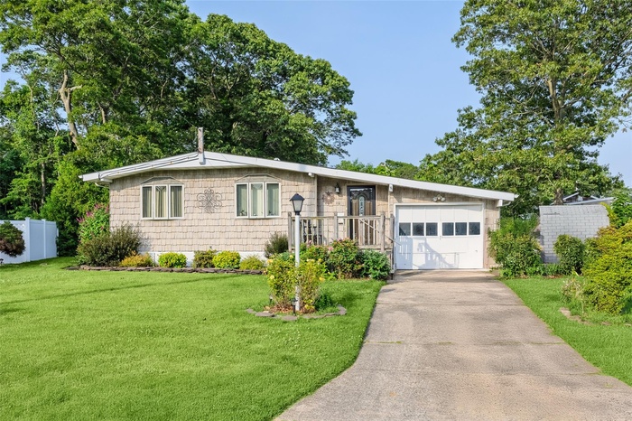 View of front facade with driveway and a garage