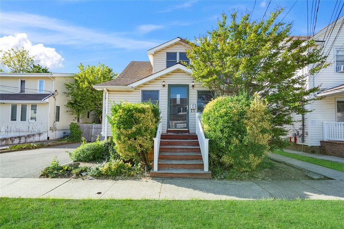 View of front of home with roof with shingles