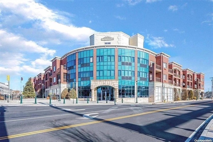 View of property featuring uncovered parking