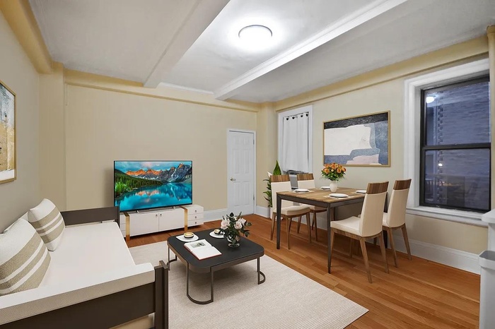 Living area with baseboards, wood finished floors, and beam ceiling