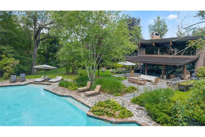 Outdoor pool with a patio and outdoor lounge area