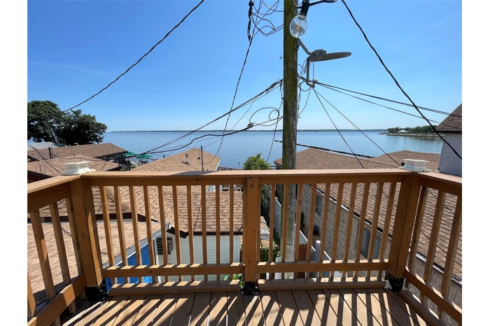 Wooden terrace featuring a water view