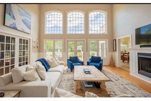 Drive down a picturesque, tree lined driveway and arrive at this stunning post modern home nestled on a spacious, 1.