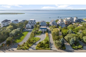 Experience the essence of relaxed coastal living, elevated by timeless design and exceptional rarity, at this unparalleled bayfront compound on Dune Road.