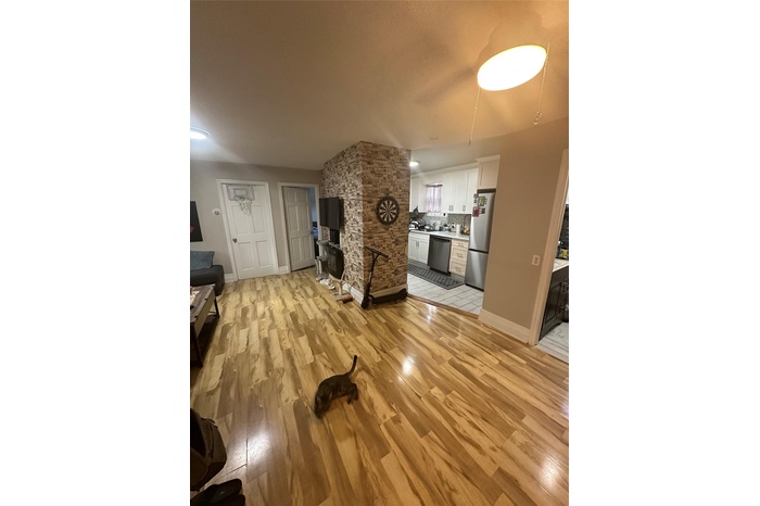 Living room with light wood finished floors and baseboards