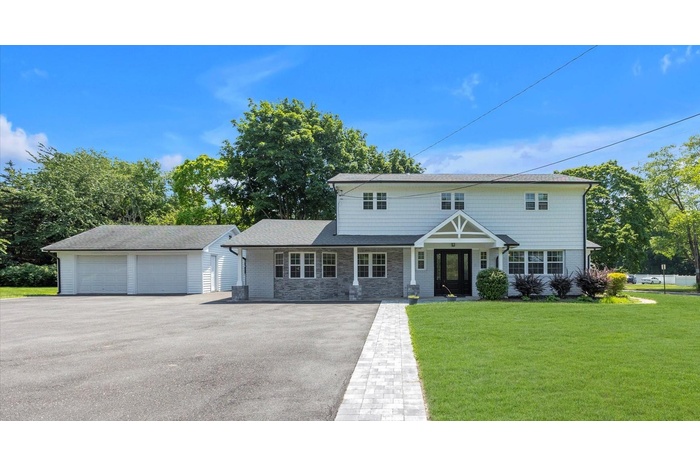 Welcome to 42 Norwood Roaddetached garage, a front yard, an outbuilding, stone siding, and a shingled roof