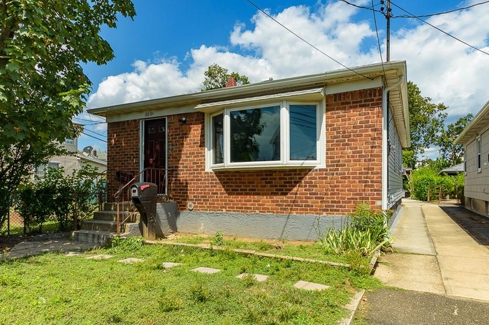 Bungalow-style house with brick siding