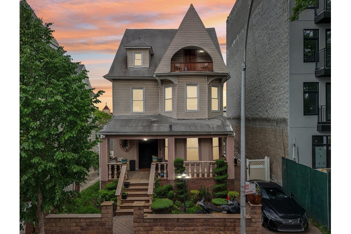 Duplex, 2-family property featuring a balcony and covered porch