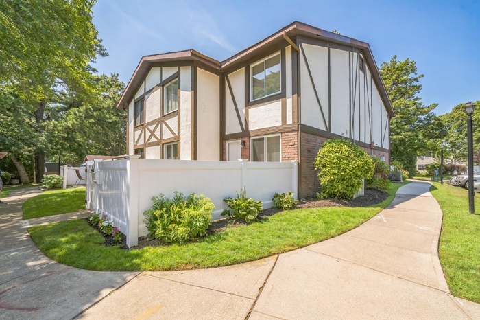 View of home's exterior featuring brick siding and stucco siding
