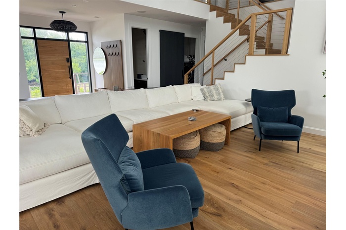 Living area featuring stairway and wood finished floors