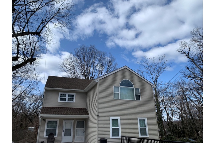 View of front of home with a shingled roof