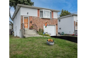 Welcome to this beautifully maintained 4 bedroom, 2 bathroom High Ranch nestled in the heart of West Babylon.