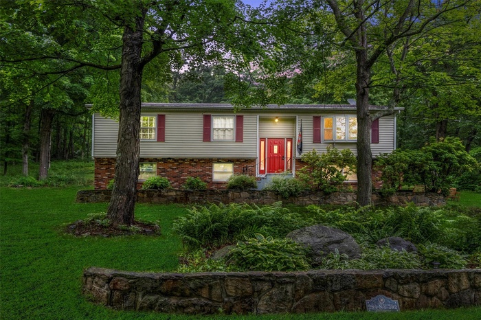 Raised ranch with a front yard