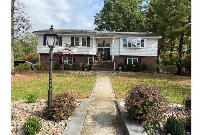 Raised ranch featuring a front lawn