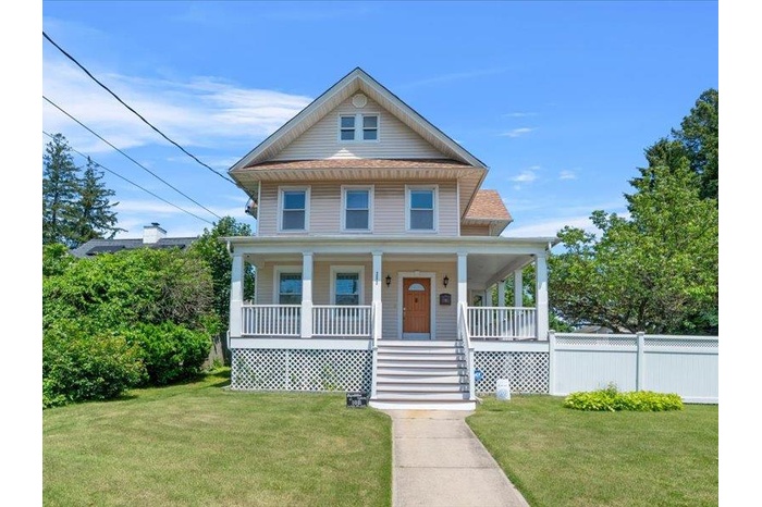 View of front of property with a wrap around porch