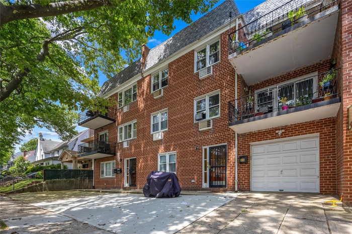 View of property with driveway and an attached garage