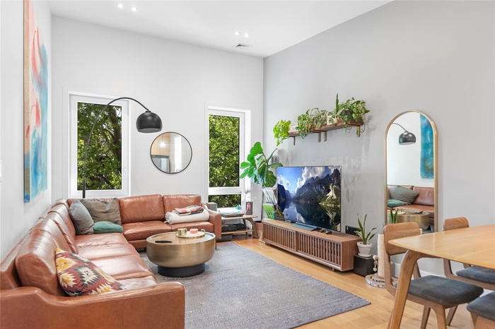 Living area featuring light wood-style flooring and recessed lighting