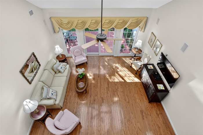 Living room featuring wood finished floors and a ceiling fan