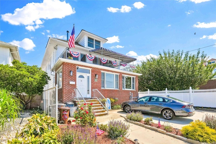 View of front facade featuring brick siding and entry steps
