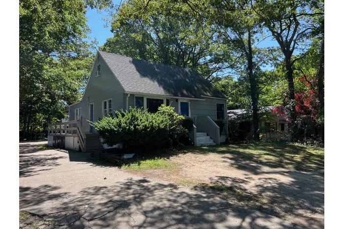 View of front of home featuring roof with shingles