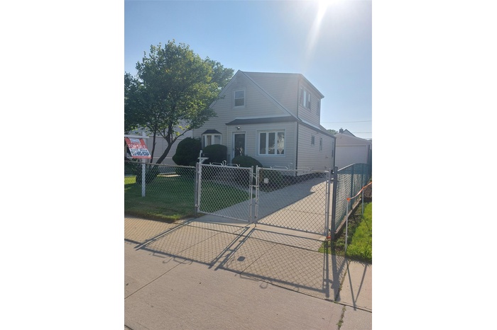 Traditional home with a gate and a fenced front yard