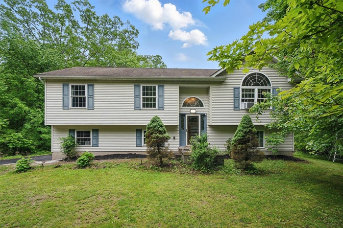 Bi-level home with a front lawn