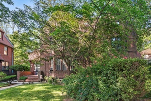 Traditional Brick home on a tree lined street in Forest Hills Gardens.
