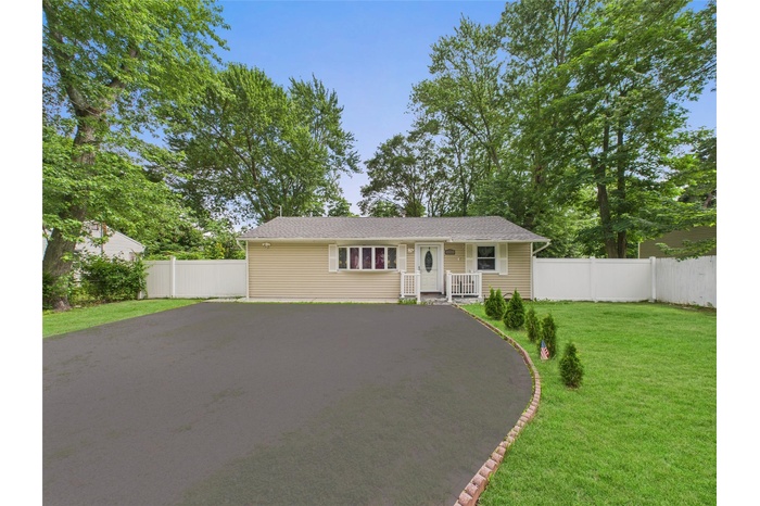 Single story home featuring asphalt driveway