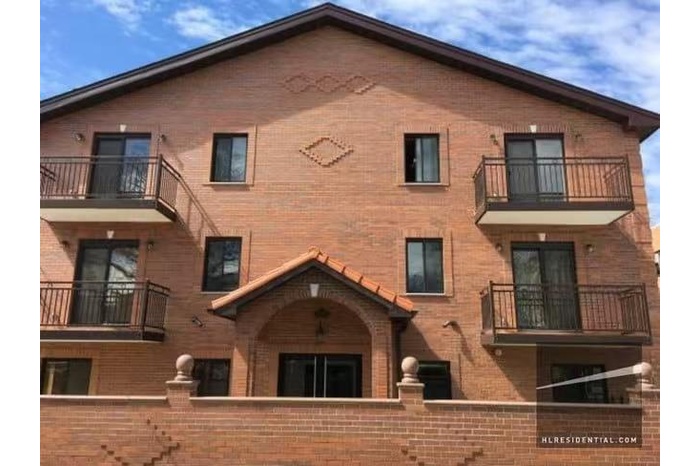 View of building exterior with a fenced front yard