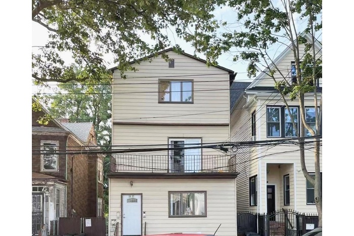 Rear view of property featuring a balcony
