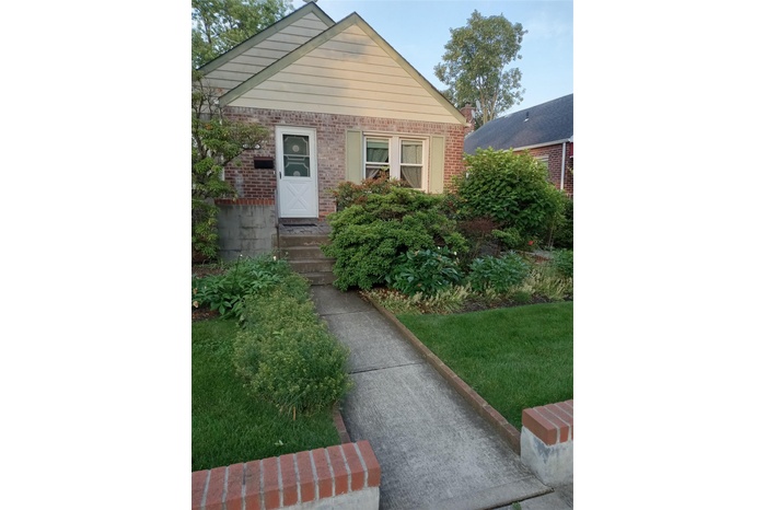 View of front of home featuring brick siding and entry steps