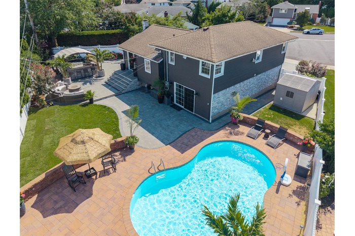 View of pool featuring a gazebo, a patio, an outbuilding, a yard, and an outdoor living space
