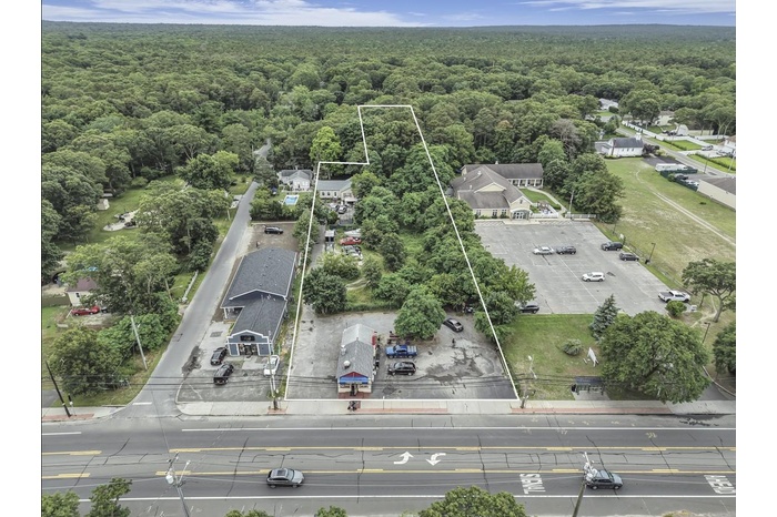 View of property location featuring a heavily wooded area and property boundaries highlighted