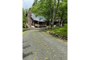 Escape the hustle and bustle of city life with this serene and secluded cabin, perfectly nestled in the woods at the end of a quiet dead end road.
