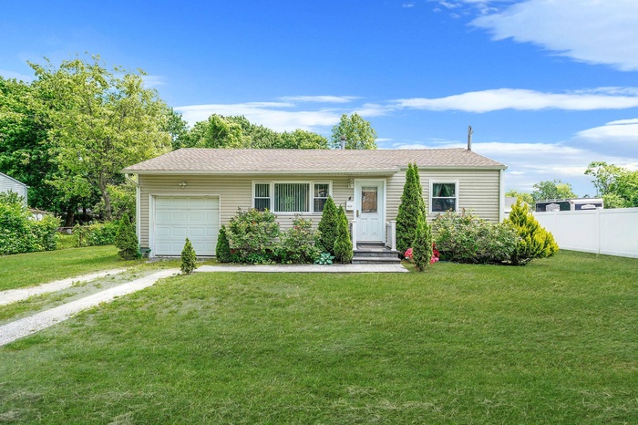Ranch-style home with driveway and a garage