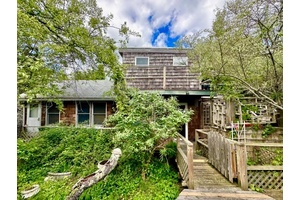PRICE REDUCED ! Charming cottage located close to town on large, private lot.