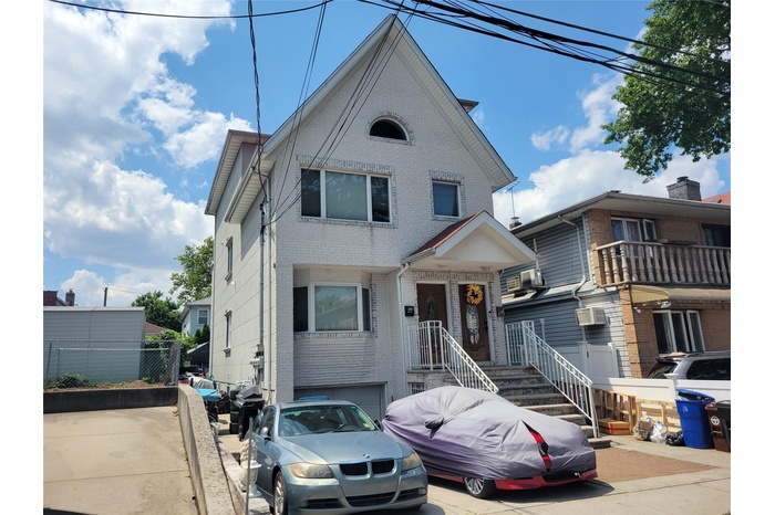 View of front of house featuring brick siding and an attached garage