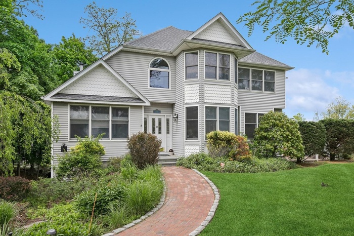 Victorian home with a front lawn, roof with shingles, and french doors