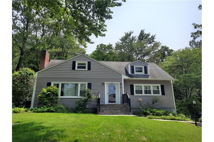 Cape cod home with a front yard
