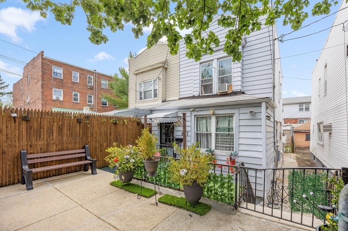 View of front of house with a fenced backyard, a patio, and cooling unit
