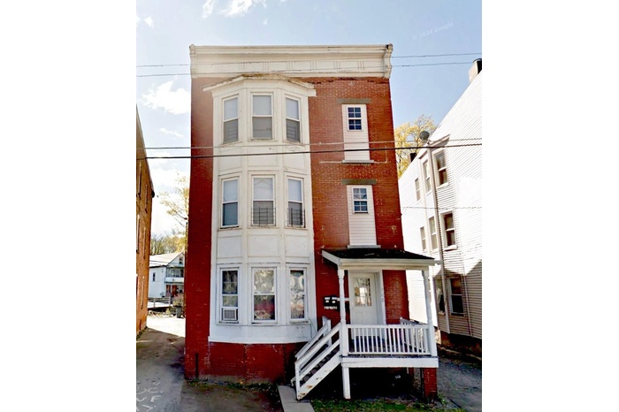 View of front facade featuring brick siding