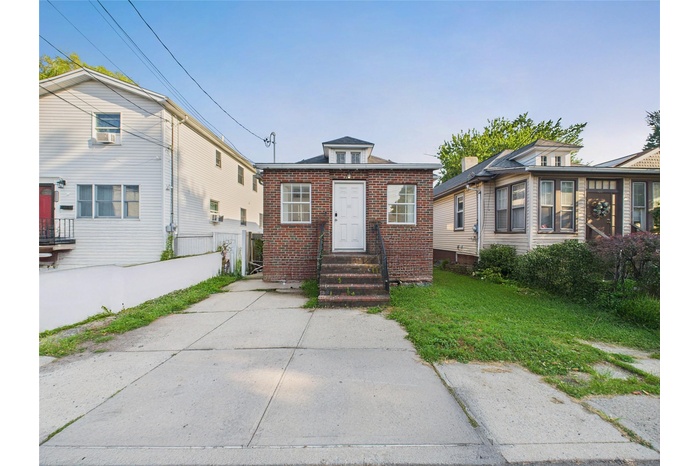View of front of house with brick siding and entry steps