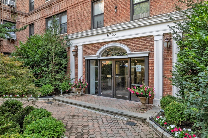 View of exterior entry with brick siding and french doors