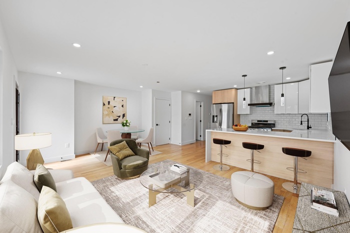 Living room featuring light wood-style flooring and recessed lighting
