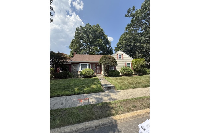 View of front of home featuring a front lawn and a chimney