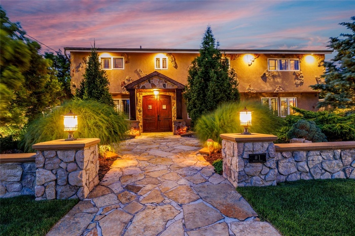 View of front of home with stone siding and stucco siding